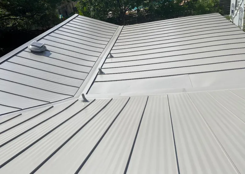 Solar attic fan installed on a metal roof for Roof Ventilation in Vernon